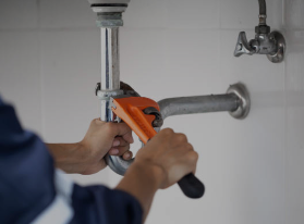 PLumbing photo of a drain and wrench